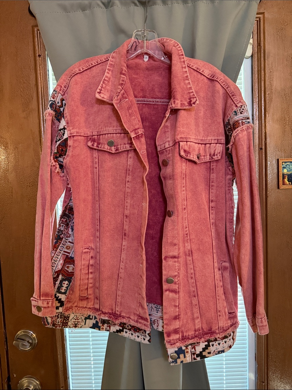 Pink denim jacket size “2”.